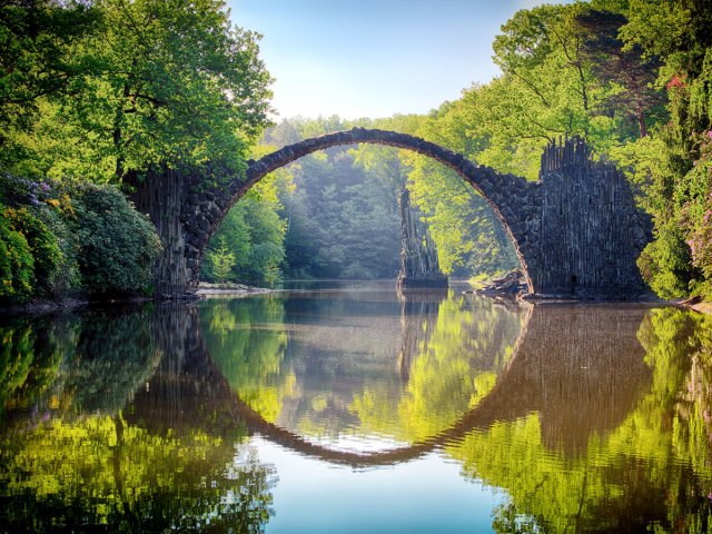 Rakotzbrücke bridge in Germany with reflection on lake creating perfect circle