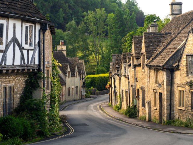 Winding street lined with homes in Castle Combe, England