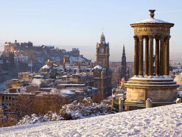 Monument on snow-covered hill overlooking Edinburgh, Scotland