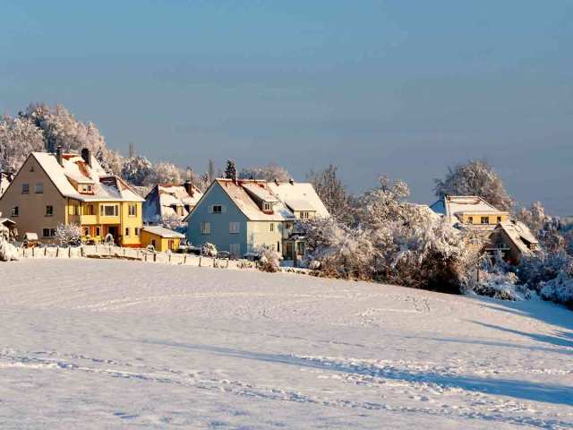 Snow-covered homes on hillside in Germany