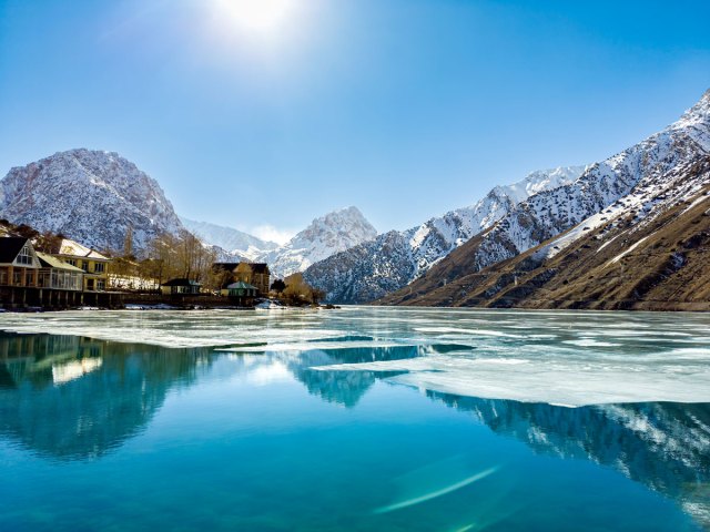 Partially frozen Iskanderkul Lake in the Tajikistan mountains
