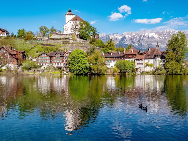 Homes and church beside lake and mountains in Liechtenstein