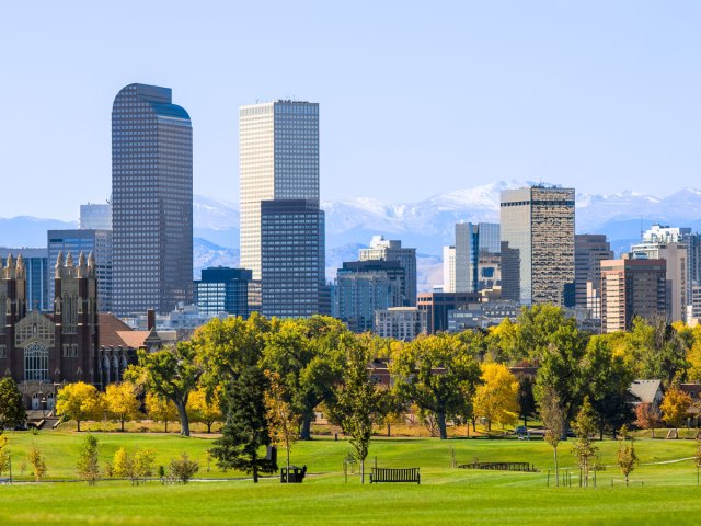 Denver, Colorado, park with skyscrapers and mountains in background