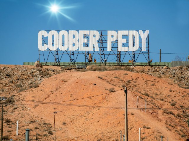 Sign for Coober Pedy, Australia, on top of sandy hill