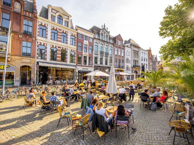 People enjoying patio on sunny day in Amsterdam, the Netherlands
