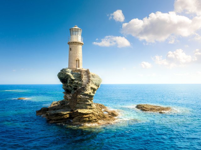 Tourlitis Lighthouse on small rocky islet in the Aegean Sea of Greece