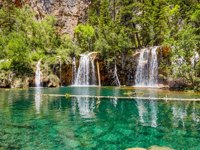 Waterfalls and foliage surrounding Hanging Lake in Colorado