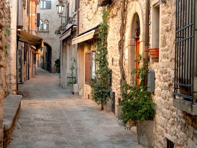 Narrow alleyway between stone houses in San Marino