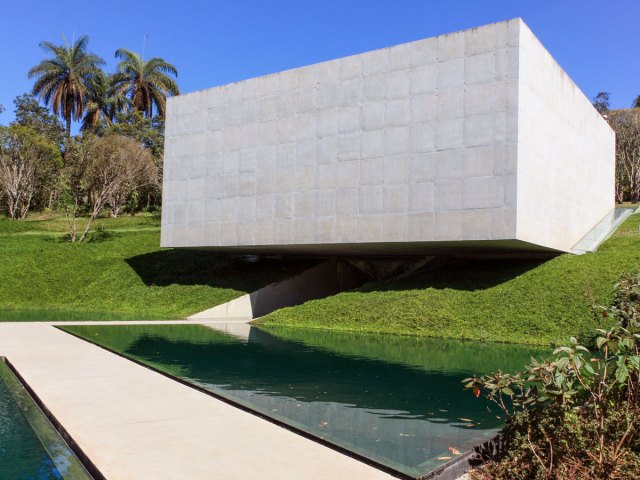 Cubical sculpture suspended over water at Inhotim Museum in Brazil