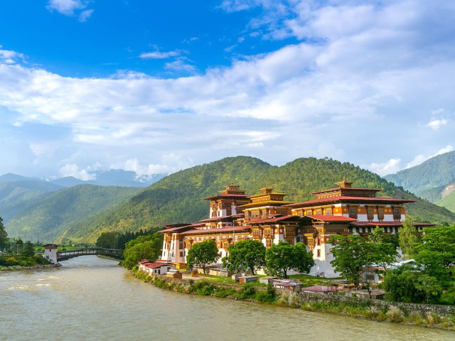 Punakha Dzong Monastery alongside river and mountains in Bhutan