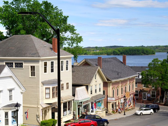 Buildings on sloping hill in Castine, Maine, with sea in background