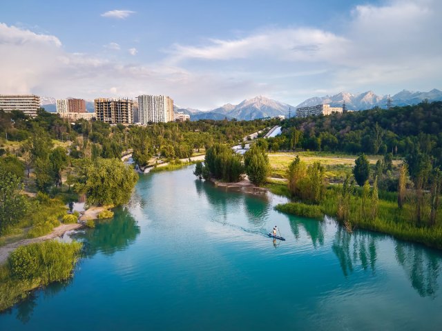Aerial view of paddle-boarder on river in Almaty, Kazakhstan