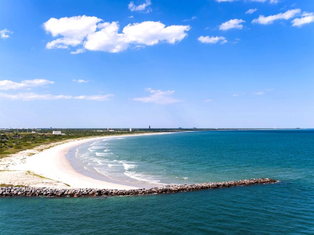 Sandy beach and rock jetty on Florida coastline