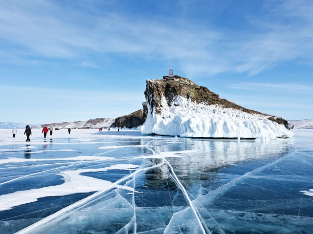 People walking on frozen ice of Lake Baikal in Siberia, Russia