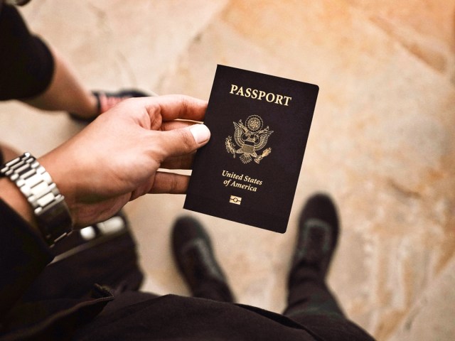 Close-up image of traveler holding U.S. passport