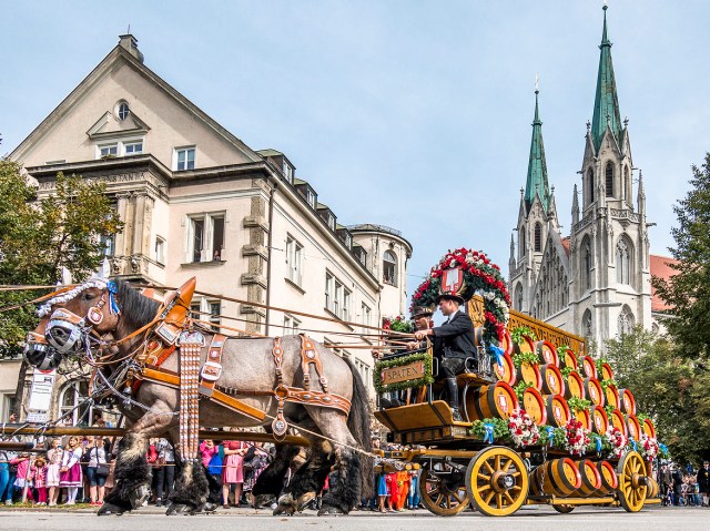 Horse-drawn carriage in Munich, Germany, with church towers in background