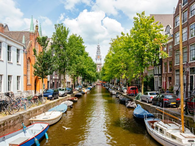 Canal lined with boats and row homes in Amsterdam, the Netherlands