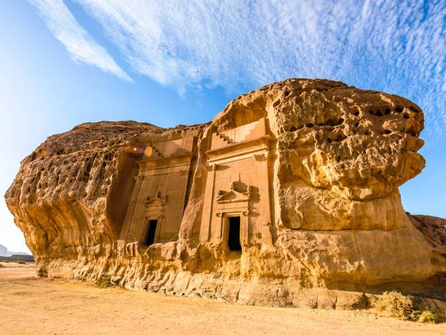 Buildings carved into side of rock in Hegra, Saudi Arabia