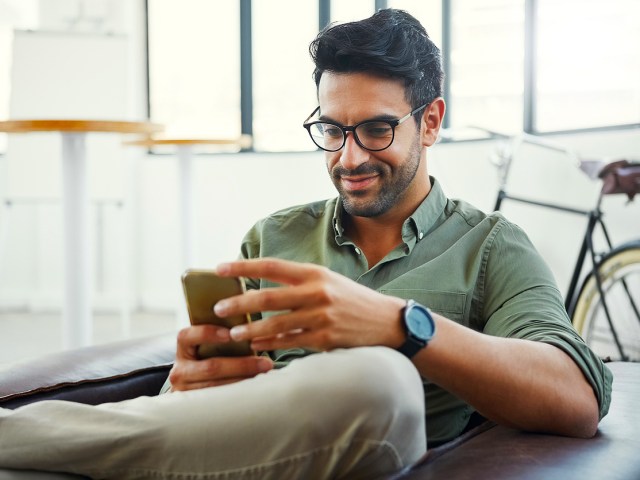 Man looking at cell phone in hand