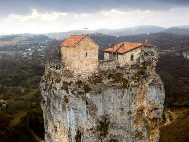 Aerial view of Katskhi Monastery dominating small, rocky mountaintop in Georgia