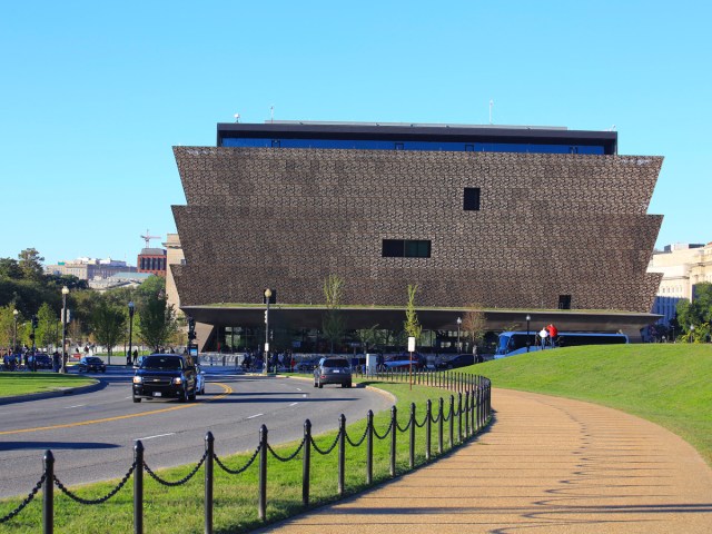 Roadway and sidewalk leading to the bronze-colored National Museum of African American History and Culture in Washington, D.C.
