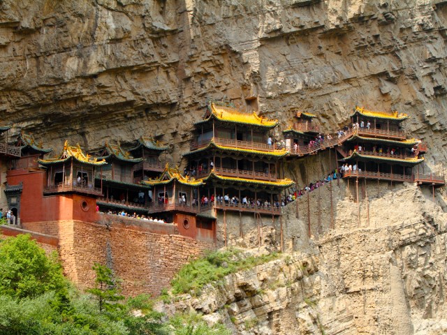 Upward-facing view of Xuankong Monastery built into side of mountain in China