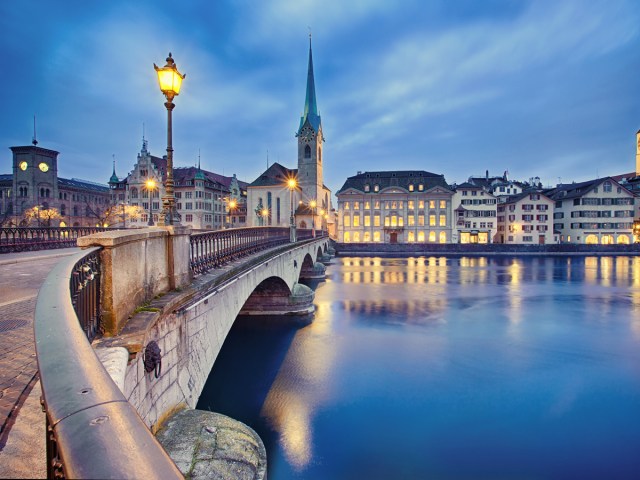 Bridge over river in Zurich, Switzerland, illuminated at night
