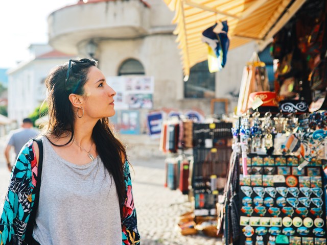 Tourist browsing outdoor market stall