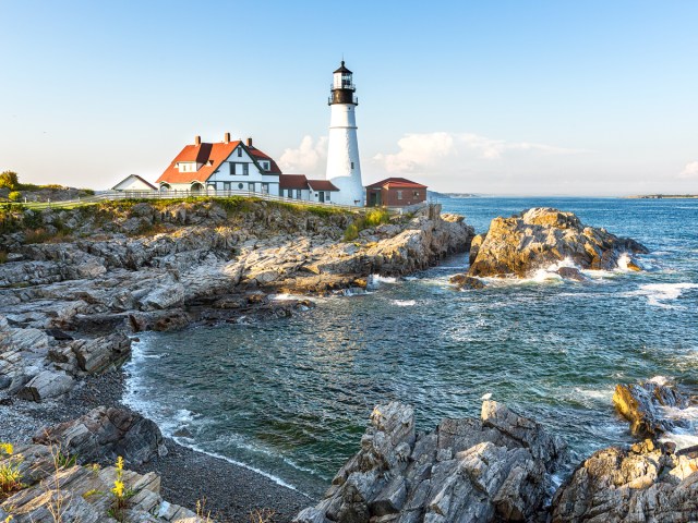 White lighthouse along rocky coast of Maine