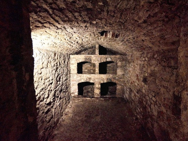 Dimly lit stone-encased underground room at Blair Street Underground Vaults in Edinburgh, Scotland