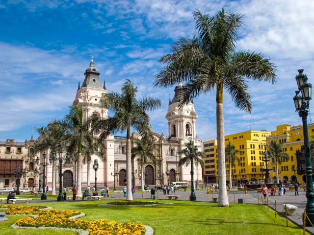 Church and city square lined with palm trees in Lima, Peru