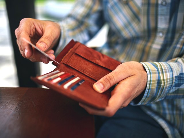 Close-up of person taking credit card out of wallet