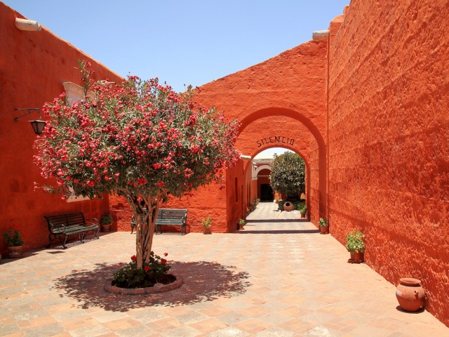 Courtyard and bright red walls of Santa Catalina monastery in Arequipa, Peru