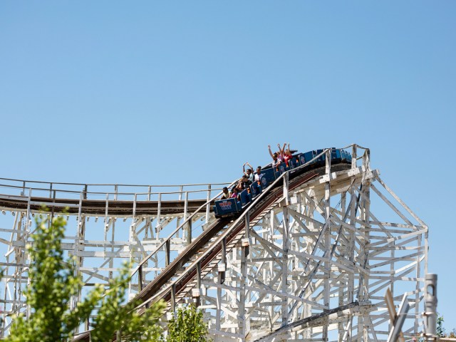 Riders throwing hands in the air for drop on the WIld One roller coaster in Maryland