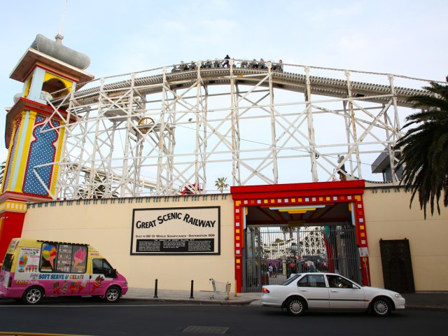 Sign for Great Scenic Railway in Melbourne, Australia, with coaster towering above