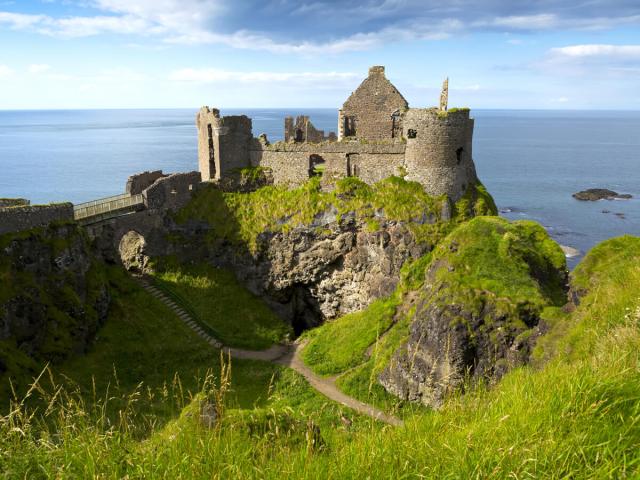 Castle ruins on cliff overlooking the sea in Ireland