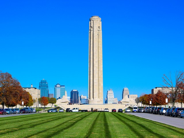 Grassy lawn in front of Liberty Memorial Tower with Kansas City skyline in background