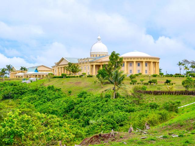 Government building seen across grassy hill in Ngerulmud, Palau
