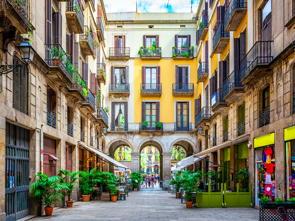 Barcelona passageway lined with apartments and ground-floor cafes