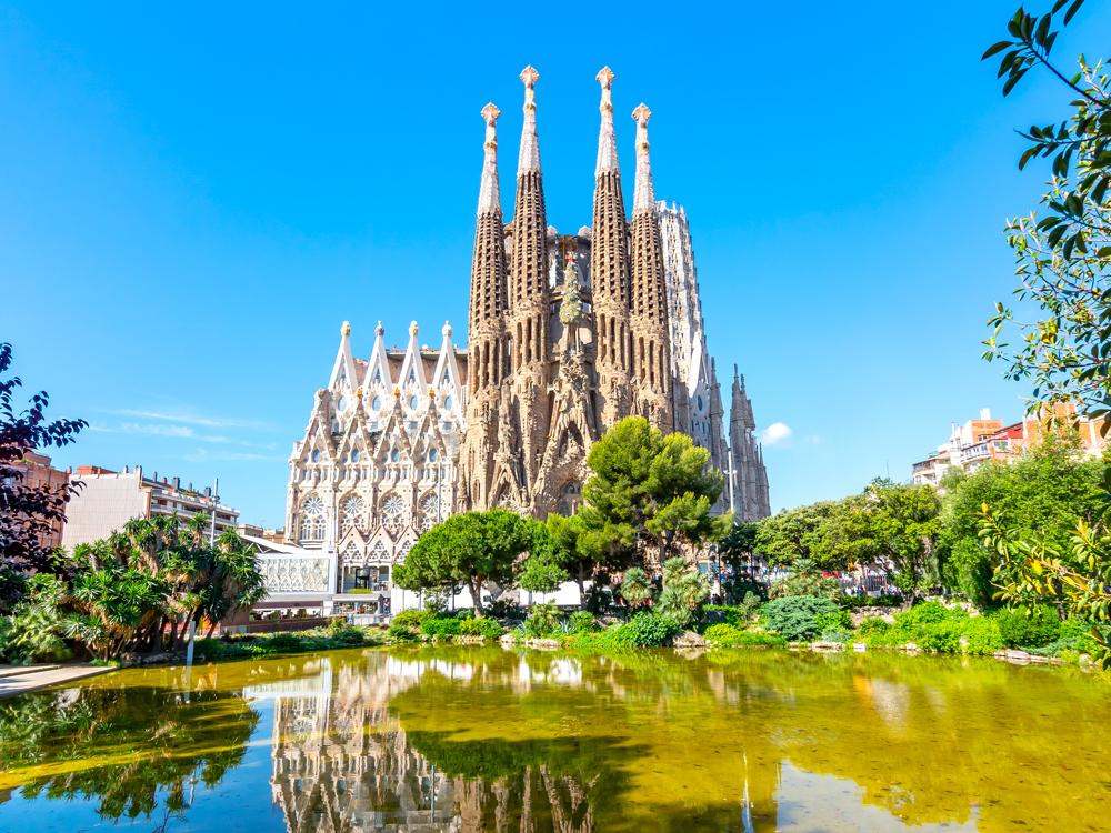 Sagrada Família church in Barcelona, Spain, seen across reflective pond