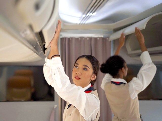 Flight attendants on airplanes closing overhead bins