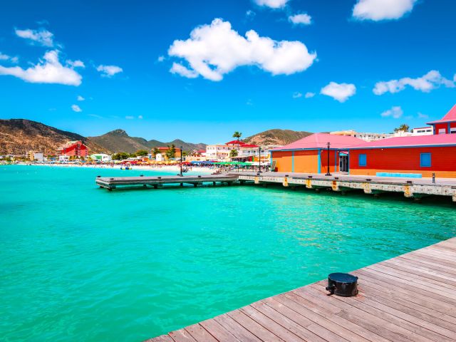 Colorful buildings on pier overlooking turquoise waters in St. Maarten