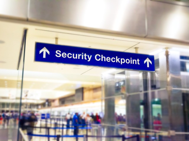 Sign at airport indicating security checkpoint