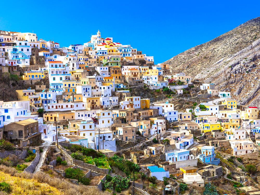 Colorful homes built on steep mountainside on the Greek islands