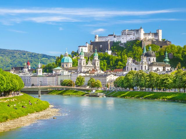 View of Hohensalzburg Castle in Salzburg, Austria, towering above city and river
