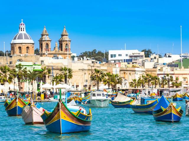 Colorful boats moored in harbor of Valletta, Malta