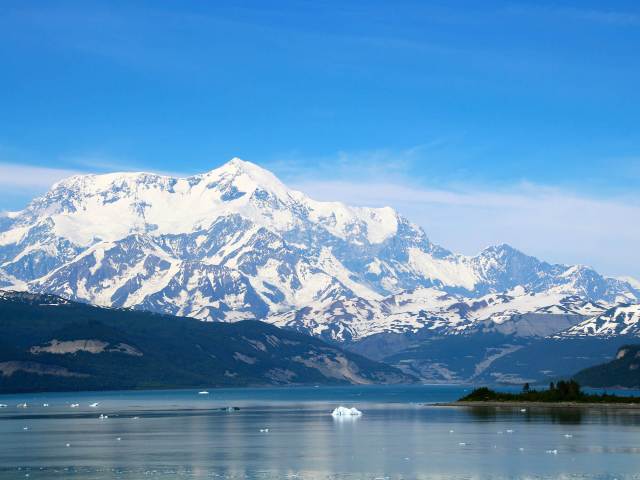 Snow-covered Mount St. Elias in Alaska with lake in foreground