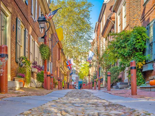 View of cobblestones and brick row homes along Elfreth's Alley in Philadelphia, Pennsylvania, from street level