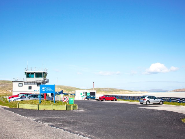 Control tower and parking lot at Barra Airport in Scotland