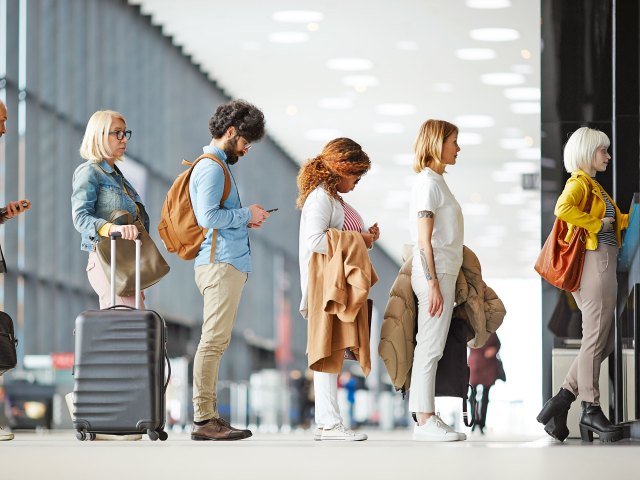 Travelers standing in line at airport